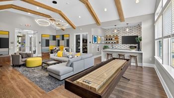 Lounge/wet bar with shuffleboard, tvs and fireplace